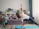 a woman and a child doing yoga in a living room